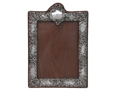 A late Victorian silver photograph frame by Henry Matthews, Birmingham 1900, rectangular with a vacant reserve to the top, pi