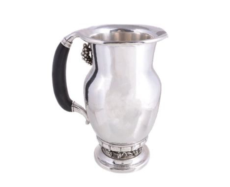 ϒ Georg Jensen, a Danish silver Grape pattern pitcher or jug, post 1945 stamped mark, design no. 407A, with an ebony handle, 