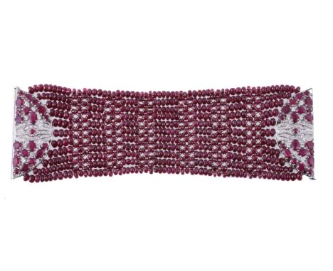 A ruby and diamond bracelet, the woven bracelet with facetted ruby beads, the clasp formed as two semi circular panels set wi