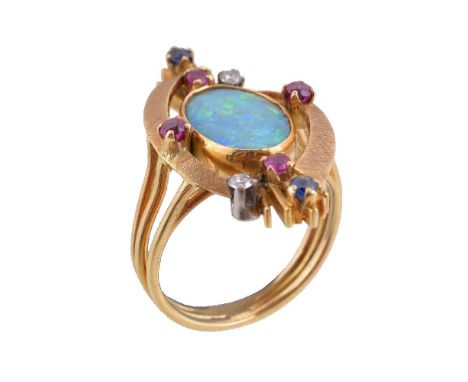 A 1970s opal doublet, ruby, sapphire and diamond dress ring, the oval opal doublet within a surround of circular cut rubies a