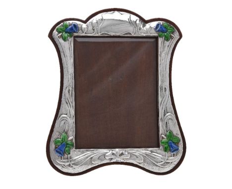 A silver photograph frame, DK&amp;S (untraced), London 1983, curved rectangular, embossed with a vacant reserve and daffodils