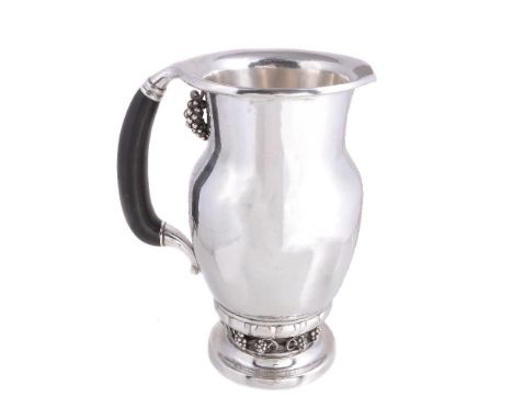 ϒ Georg Jensen, a Danish silver Grape pattern pitcher or jug, post 1945 stamped mark, design no. 407A, with an ebony handle, 