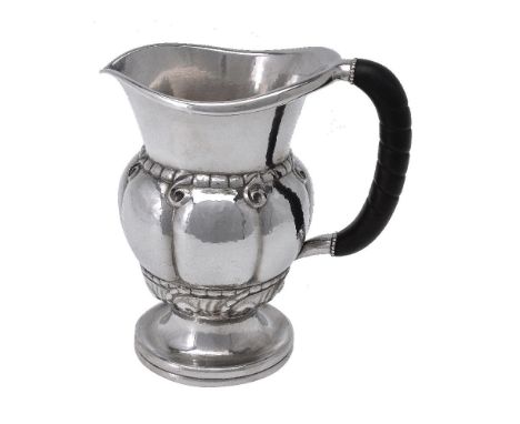 ϒGeorg Jensen, a Danish silver water jug or pitcher, post 1945 stamped marks, design no. 7, with an ebony handle, 20cm (8in) 