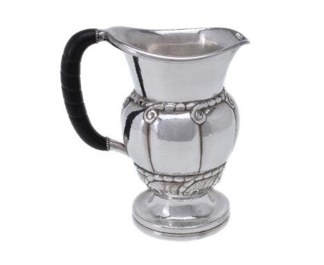 ϒGeorg Jensen, a Danish silver water jug or pitcher, post 1945 stamped marks, design no. 7, with an ebony handle, 20cm (8in) 