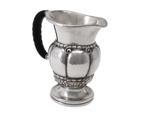 ϒ  Georg Jensen, a Danish silver water jug or pitcher, post 1945 stamped marks, design no. 7, with an ebony handle, 20cm (8in