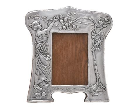 An Edwardian silver photograph frame by Charles S. Green &amp; Co., Birmingham 1904, Rd. No. 427887, curved rectangular, embo