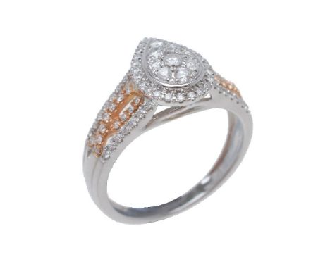 A diamond dress ring, the pear shaped panel set with brilliant cut diamonds, between brilliant cut diamond set shoulders, app