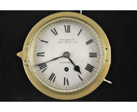 A late 19th/early 20th century brass bulkhead ship's clock, dial inscribed Harris, Upper Thames Street, London - 15cm silvere