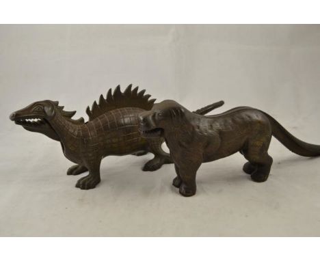 A cast metal 'dinosaur' nutcracker - L36cm, together with a metal nutcracker in the form of a dog - L31cm CONDITION REPORT: g