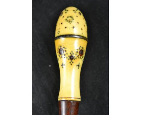 An ivory handled walking stick with pique work and horn roundels to 10cm handle - overall length 89cm CONDITION REPORT: Sligh