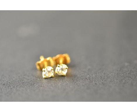 A pair of 18ct gold diamond stud earrings, each diamond  modern brilliant cut and 0.25 carat, clarity SI colour K.