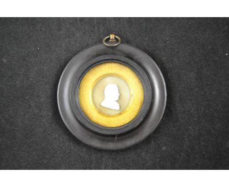 An early 19th century Tassie style portrait of the Reverend Alex Waugh, dated 1827, circular ebonized frame - diam 9cm CONDIT