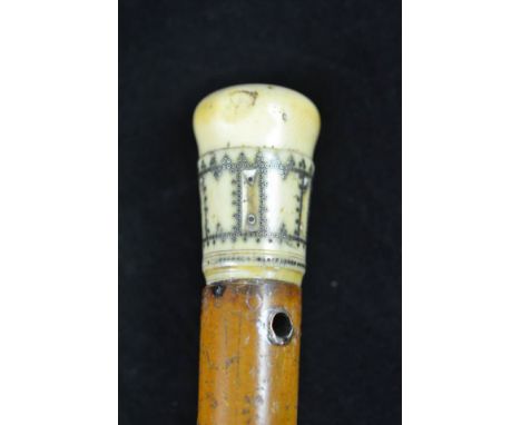 An ivory and pique work malacca walking stick, the 5cm late 17th/early 18th century handle with silver inlaid pique work, no 