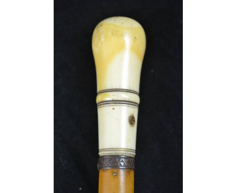 An ivory handled malacca walking stick, the 9.5cm collared handle with filled piercing, floral pattern collar, metal ferrule 