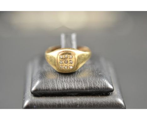 A 9ct gold signet ring inset with nine diamonds, size R 1/2 - approx gross weight 3.3g