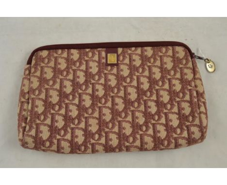 A vintage Dior monogram clutch/cosmetic purse in the burgundy colourway, zip fastening to top, applied gilt metal logo to ext