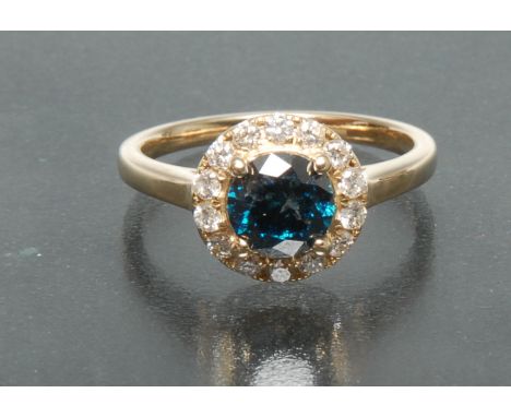 A fancy blue and white diamond ring, central round brilliant cut blue diamond, approx 1.0ct, above a surrounding band of four