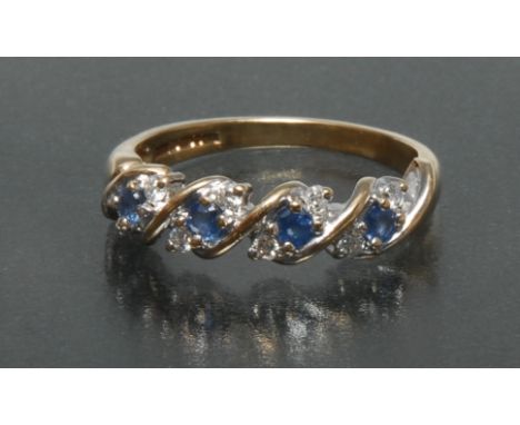 A sapphire and diamond wave crest ring, inset with four round pale blue sapphires and eight round brilliant cut diamonds, tot