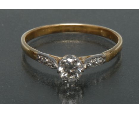 A solitaire diamond ring, round brilliant cut diamond approx 0.35ct, six claw white gold crown, diamond accented shoulders  i