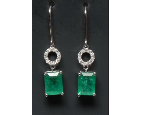 A pair of emerald and diamond earrings, each with a rectangular emerald droplet terminal approx 1.63ct, suspended from an ele