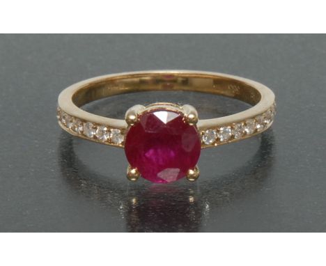 A ruby and diamond ring, central deep red round cut ruby, approx 1.74ct, surrounded by a band of sixteen round brilliant cut 