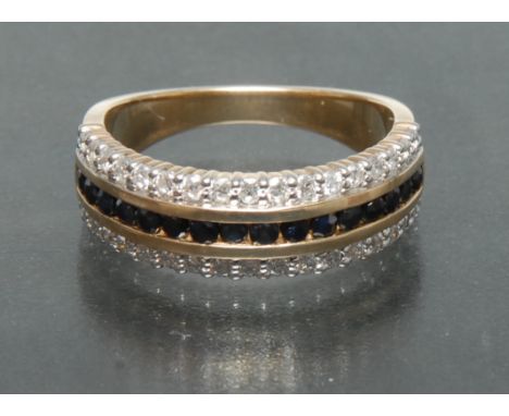 A sapphire and diamond eternity ring, central row of sixteen dark blue round sapphires, flanked either side by a seventeen ro