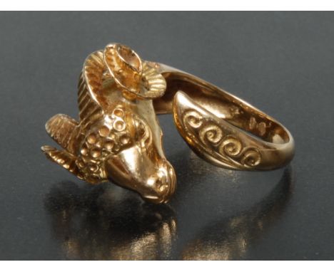 A Gentleman' rams head signet ring, open shank with rams head and tail terminals, indistinctly marked yellow metal body, poss