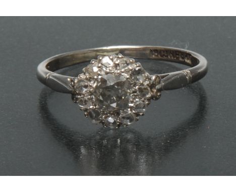 A diamond cluster ring, central old cut diamond approx 0.45ct, surrounded by a band of eleven rose cut diamonds, total estima