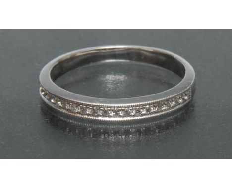 A diamond line ring, channel set with twenty one round brilliant cut diamonds, total estimated diamond weight approx 0.20ct, 