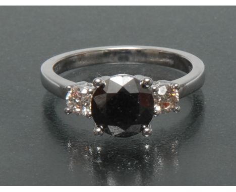 A contemporary black, white and champagne diamond trilogy ring, central black round cut diamond approx 1.53ct, flanked either