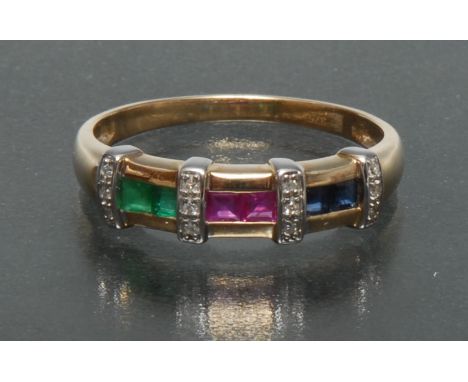 A multi gem diamond, emerald, sapphire and ruby dress ring, three section crest inset with pairs of square cut blue sapphires