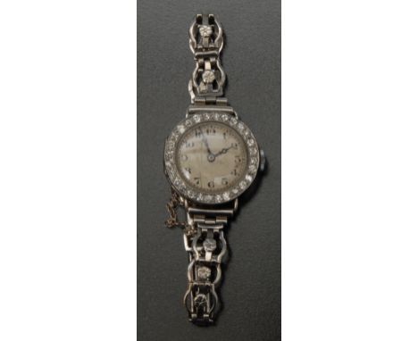 A Sanders Kensington diamond set cocktail watch, silver dial, Arabic numerals, ornate white metal case inset with a band of t