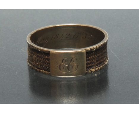 A 19th century hair work and yellow metal mourning ring, woven hairwork channel and initialled external crest, inscribed In M