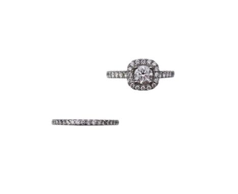 A diamond engagement ring and half eternity ring, the diamond engagement ring set with a brilliant-cut diamond weighing appro