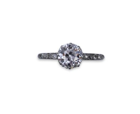 An attractive diamond engagement ring, early 20th century, claw-set with a circular-cut diamond weighing approximately 1.50 c