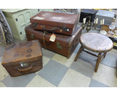 A steamer trunk two leather cases and a stool