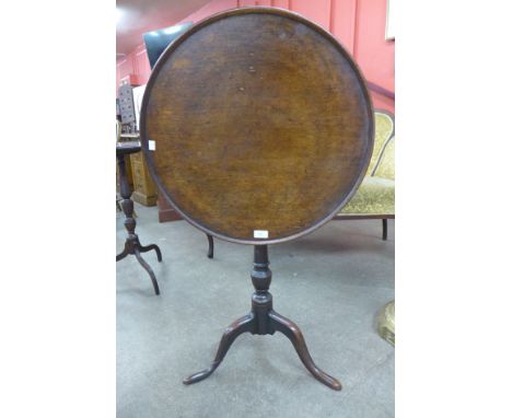 A George III mahogany circular tilt top tripod table