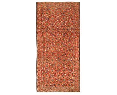 A Persian Ersari long rug, first quarter 20th century, the central field with repeating geometric floral motifs, on a terraco