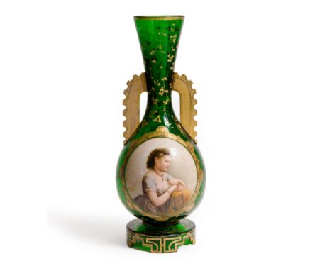 A large Bohemian green glass two-handled vase, late 19th century, of baluster form with flaring rim, the neck and upper body 