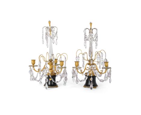 A pair of Swedish gilt and patinated bronze three-light candelabra, early 19th century, surmounted with a quiver of arrows ab