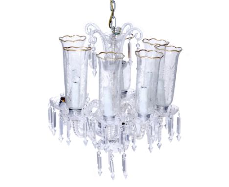 A Victorian style eight-light glass chandelier, 20th century, with scrolling finials suspending cut glass drops above knopped