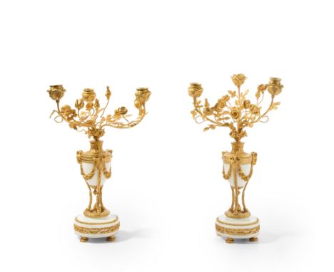 A near pair of French gilt-bronze mounted white marble three-light candelabra, of Louis XVI style, late 19th / early 20th cen