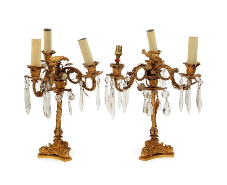 A pair of gilt-bronze three-light candelabra, 19th century, each surmounted with a bird to centre above scrolling ropetwist b