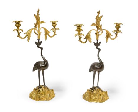 A pair of William IV gilt and patinated bronze twin-light candelabra, by Thomas Abbott, c.1830, each modelled as a stork perc
