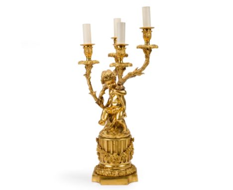 A French gilt-bronze four-light candelabra, in the manner of Clodion, early 20th century, with fruiting vine branches and dri