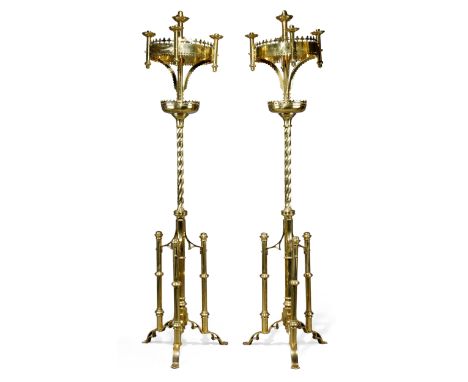 A pair of English brass five-light floor standing candelabra, of Gothic style, first quarter 20th century, each with scallope