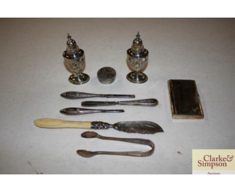 A pair of white metal pepperettes, a Victorian silver bladed butter knife with bone handle, a circular white metal patch box 