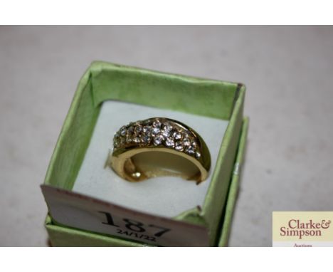 A diamante and yellow metal ring