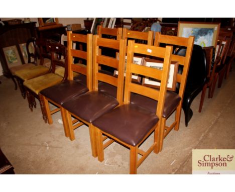 A set of six modern light oak ladder back dinning chairs