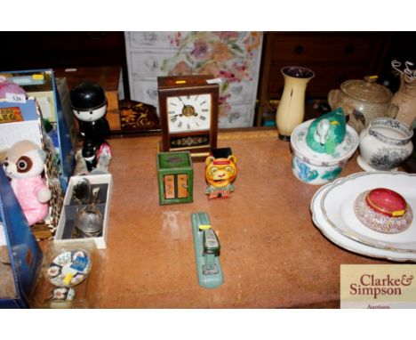 An American mantel clock; a tin plate; money box in the form of a safe; a tin plate Lyons Toffee money box; vintage stapler e